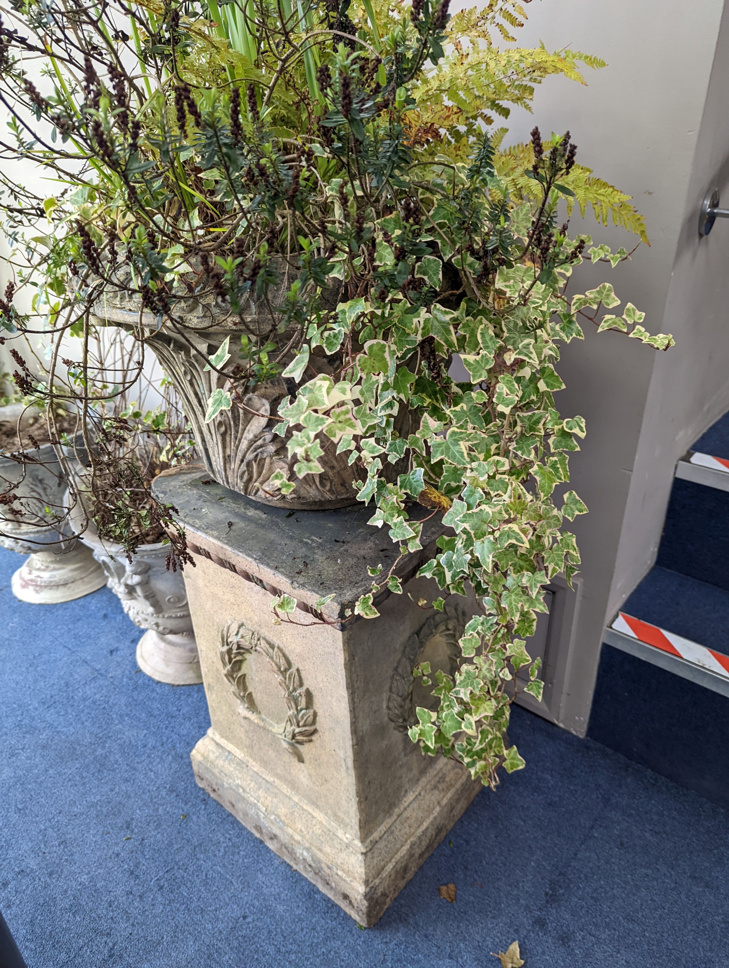 A pair of Victorian earthenware circular garden urns square plinth bases, diameter 58cm, height 96cm